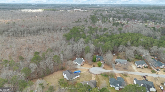 drone / aerial view featuring a forest view