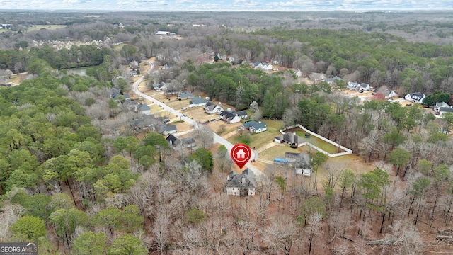 birds eye view of property with a forest view