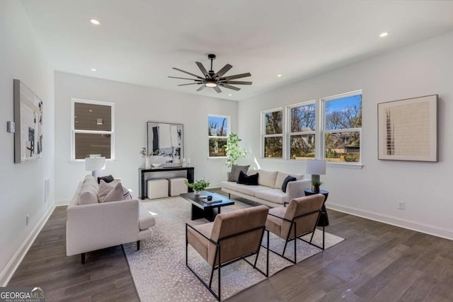 living area featuring a ceiling fan, baseboards, dark wood-type flooring, and recessed lighting