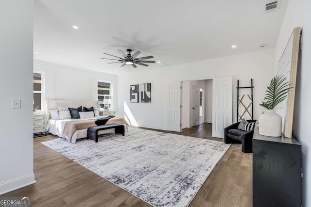 bedroom featuring baseboards, visible vents, dark wood finished floors, a ceiling fan, and recessed lighting