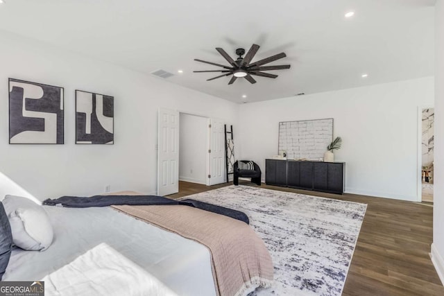 bedroom with baseboards, visible vents, dark wood-type flooring, and recessed lighting