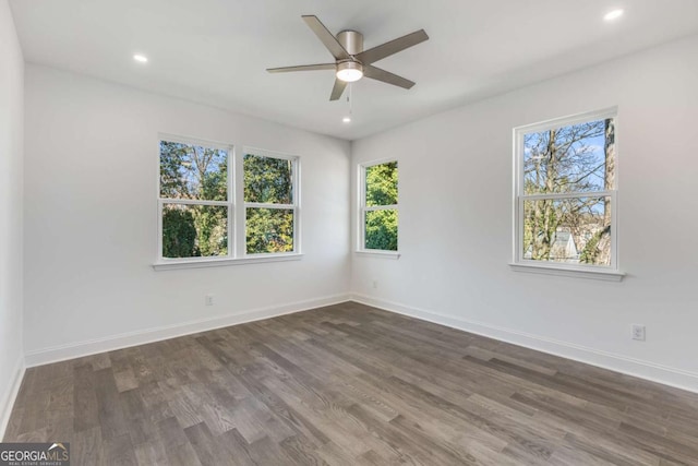 empty room with recessed lighting, baseboards, and wood finished floors