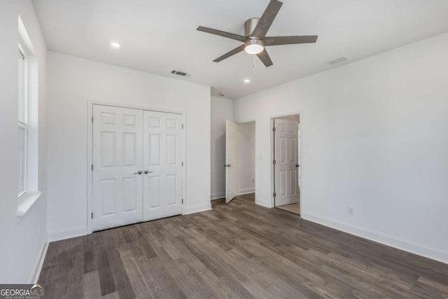 unfurnished bedroom with visible vents, baseboards, and wood finished floors