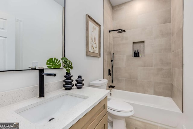 bathroom with bathtub / shower combination, vanity, and toilet