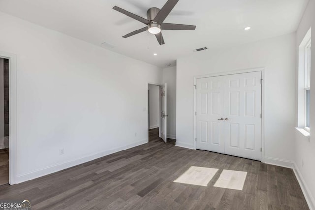 unfurnished bedroom with baseboards, visible vents, wood finished floors, and recessed lighting