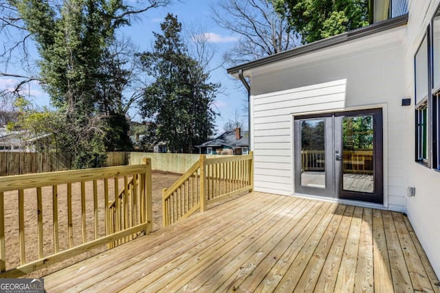 wooden deck with a fenced backyard