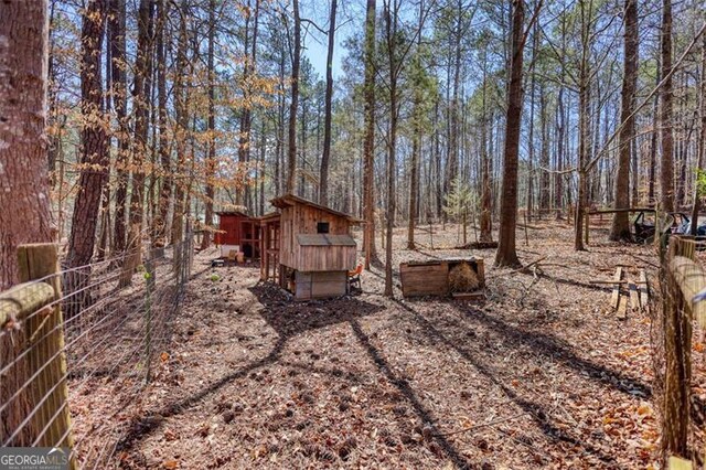 view of yard featuring a forest view