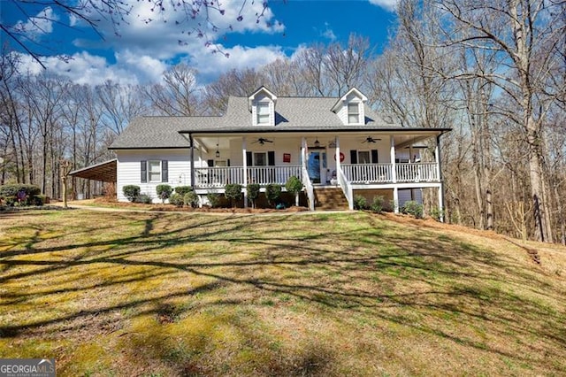 farmhouse featuring ceiling fan, a porch, a carport, and a front yard