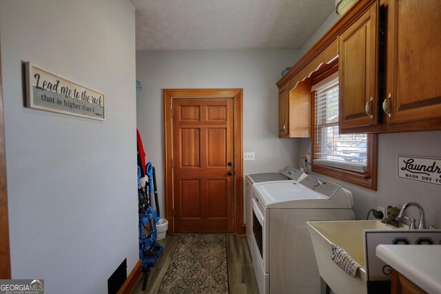 half bath with toilet, visible vents, a sink, and wood finished floors