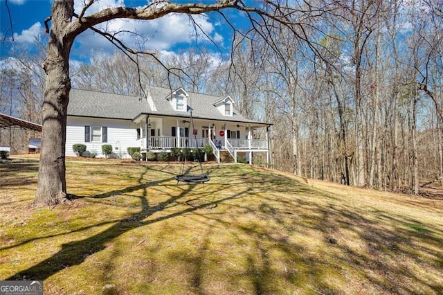 view of front of home with a porch and a front lawn