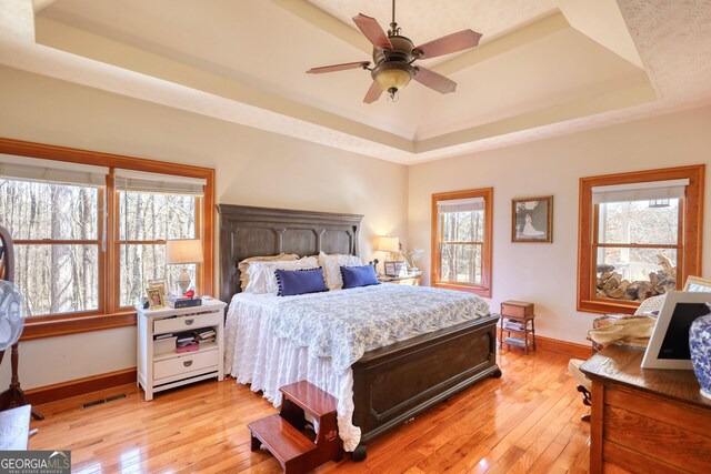 laundry room with cabinet space, washing machine and dryer, a sink, a textured ceiling, and light wood-type flooring