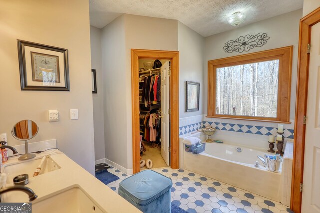 bathroom featuring double vanity, a sink, and baseboards