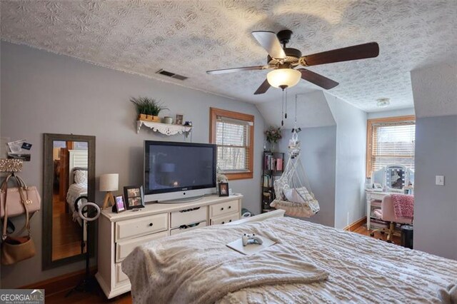 full bathroom featuring a garden tub, a spacious closet, a textured ceiling, and a sink