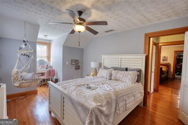 full bathroom featuring a textured ceiling, toilet, vanity, visible vents, and shower / bath combo with shower curtain