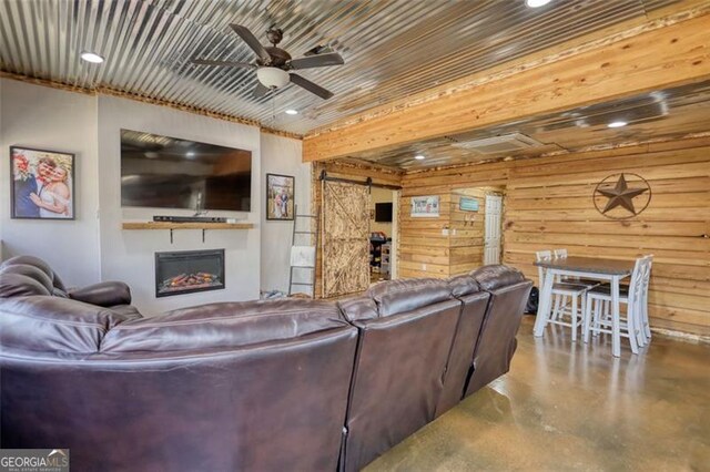 living area with finished concrete floors and ceiling fan