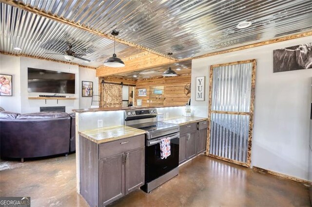 living area featuring finished concrete floors, a fireplace, and a ceiling fan