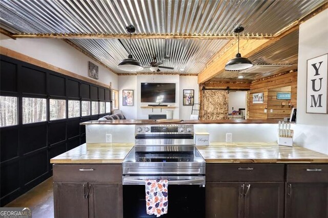 kitchen with stainless steel appliances, finished concrete floors, light brown cabinets, a sink, and butcher block countertops