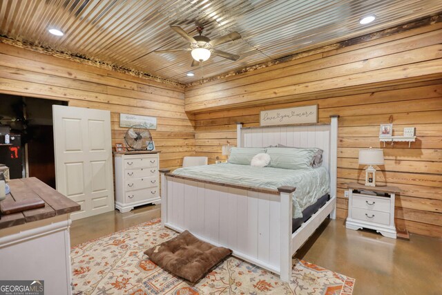 dining area with concrete flooring, wooden walls, and a barn door