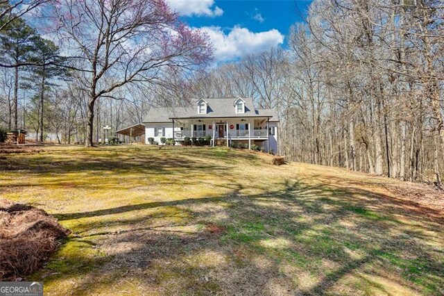 view of side of property with ceiling fan, a yard, and a garage