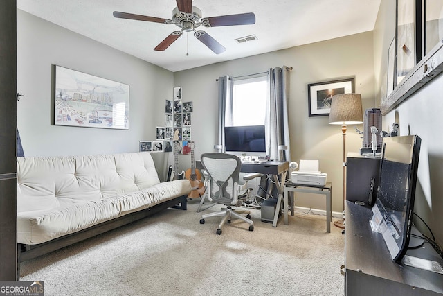 carpeted office featuring a textured ceiling, ceiling fan, visible vents, and baseboards