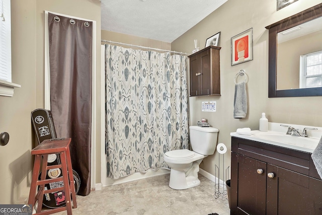 full bathroom featuring a textured ceiling, toilet, vanity, and baseboards