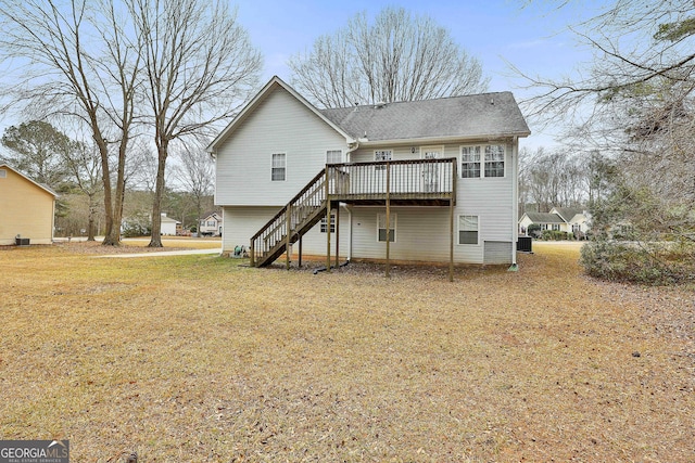 back of property with a yard, stairway, and a wooden deck