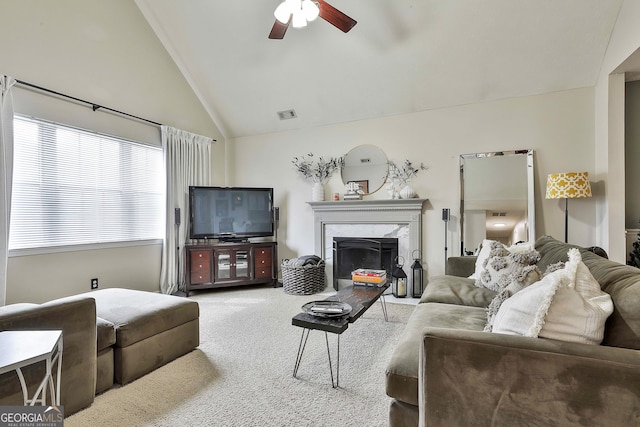 living room with carpet, visible vents, a premium fireplace, a ceiling fan, and high vaulted ceiling