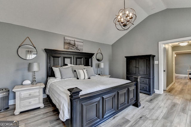 bedroom featuring lofted ceiling, light wood finished floors, baseboards, and a chandelier