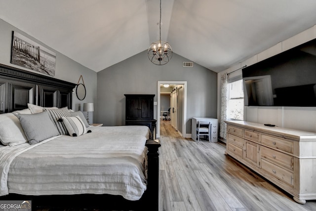 bedroom featuring light wood-style floors, lofted ceiling, a chandelier, and visible vents