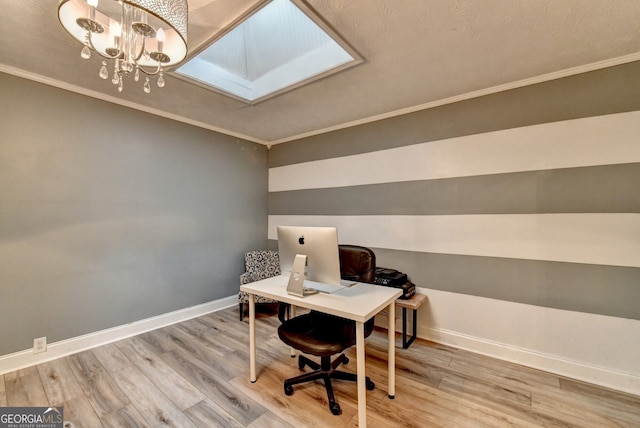 office space featuring a skylight, baseboards, wood finished floors, and ornamental molding