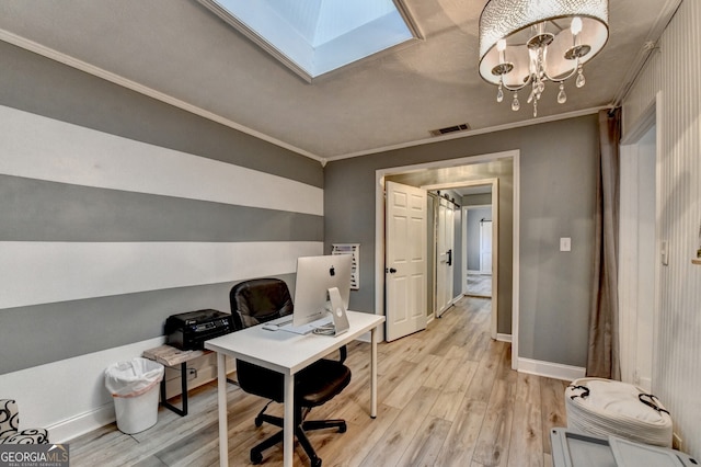 office featuring a skylight, visible vents, ornamental molding, light wood finished floors, and an inviting chandelier