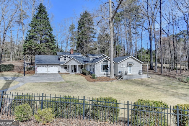 view of front of house featuring a garage, a chimney, aphalt driveway, fence, and a front yard