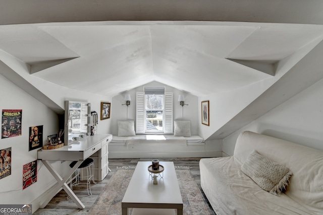 interior space featuring lofted ceiling and wood finished floors