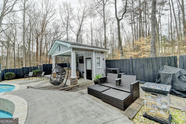 view of patio / terrace with a fenced backyard, a storage structure, an outdoor structure, a grill, and a fenced in pool