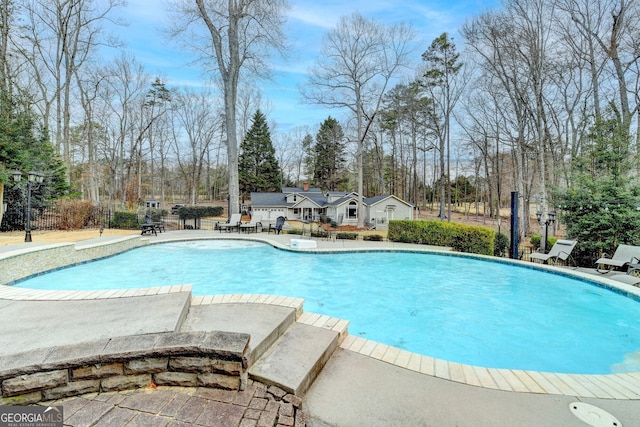 pool featuring a patio area and fence