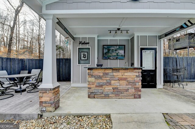 view of patio with fence and a ceiling fan