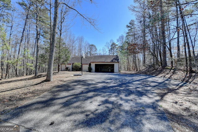 view of home's exterior featuring an attached garage and driveway