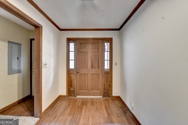 foyer featuring electric panel, baseboards, visible vents, light wood-style flooring, and crown molding