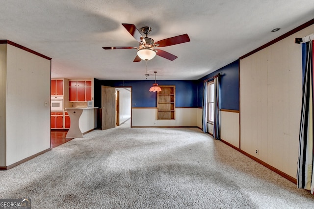 unfurnished living room with carpet, ceiling fan, and a textured ceiling