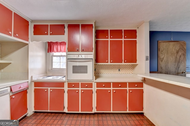 kitchen featuring white appliances, red cabinets, and tile patterned floors