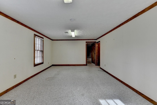 unfurnished room featuring ornamental molding and baseboards