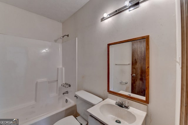 full bath featuring tub / shower combination, vanity, and toilet