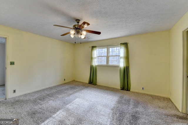 spare room featuring ceiling fan, carpet floors, and a textured ceiling