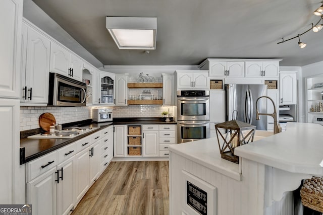 kitchen with open shelves, light wood-style floors, white cabinets, and stainless steel appliances