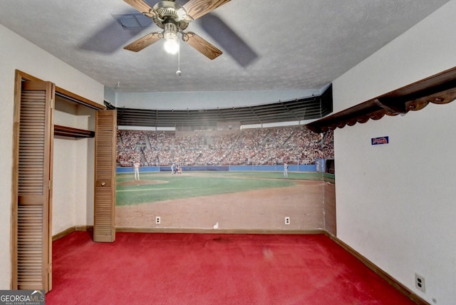 interior space with a ceiling fan, a closet, baseboards, and carpet flooring