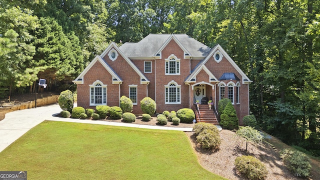 view of front of property featuring a front lawn and brick siding