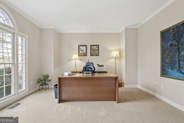 home office with ornamental molding, a healthy amount of sunlight, visible vents, and light colored carpet