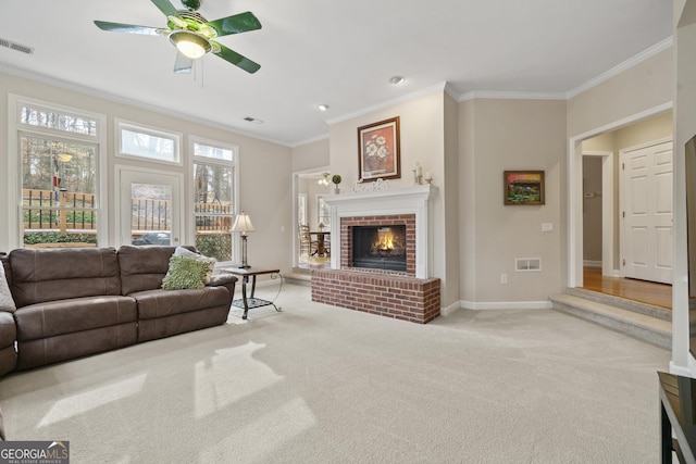 carpeted living room with ornamental molding, a brick fireplace, visible vents, and baseboards