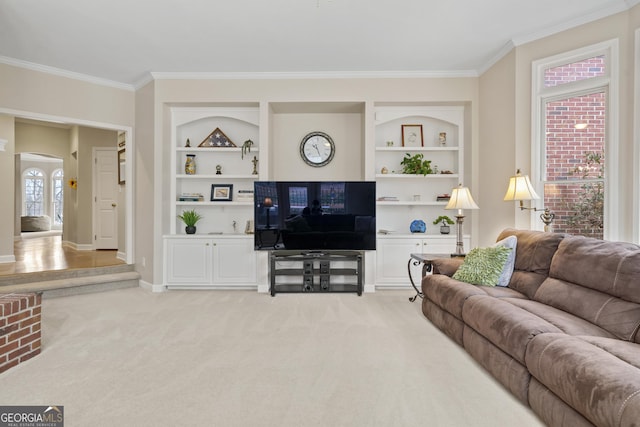 living room with built in shelves, arched walkways, ornamental molding, light carpet, and baseboards