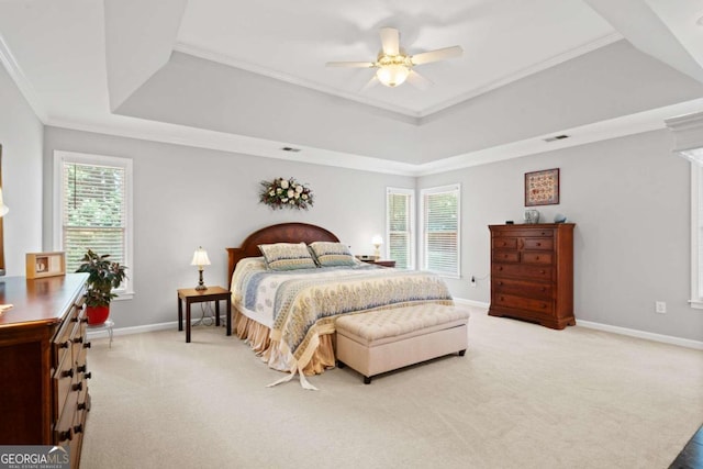 bedroom with baseboards, a raised ceiling, and light colored carpet